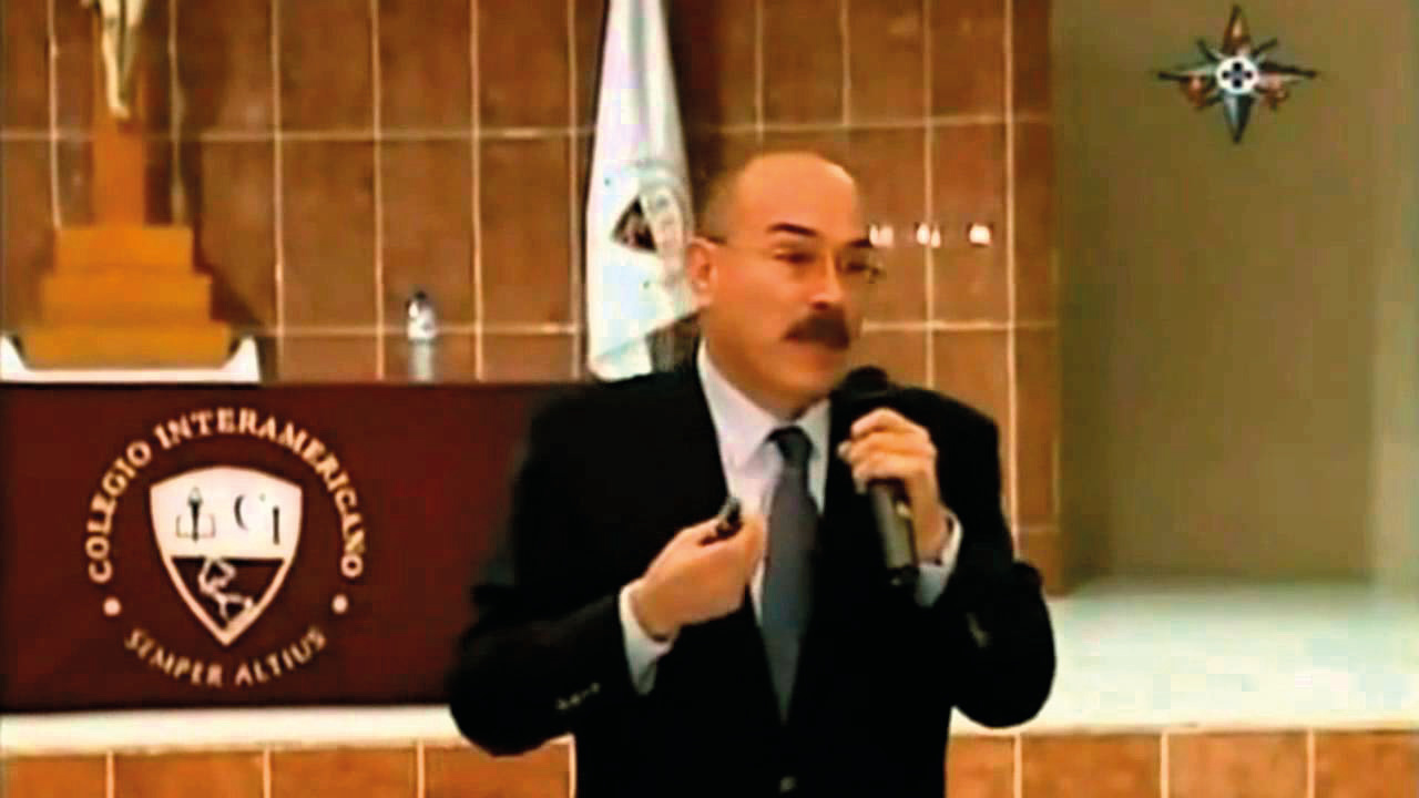 Professor Ricardo Castañón Gómez shows one of the fragment samples of the Host that transformed in 1992