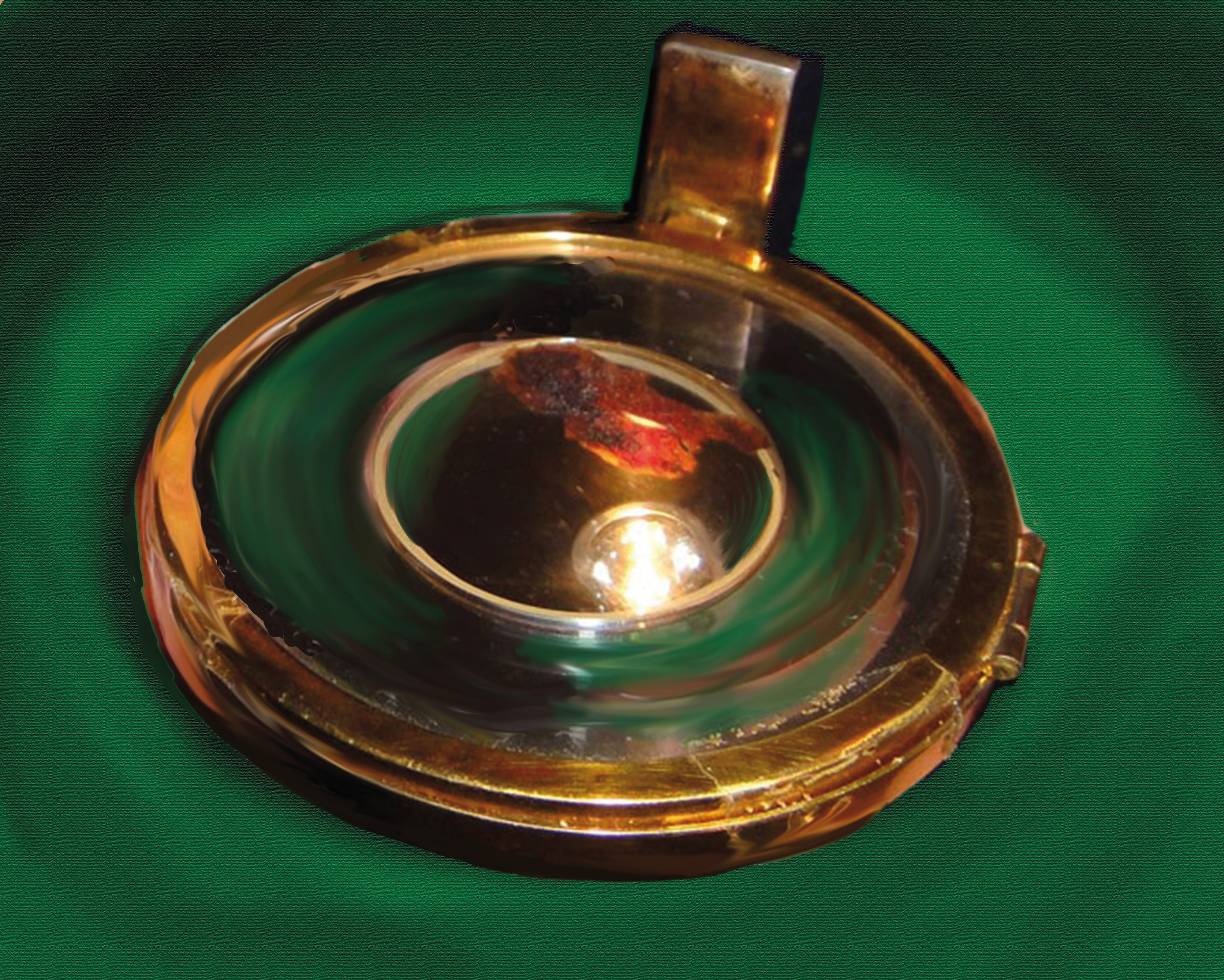 Gold circular reliquary preserving the consecrated Host that transformed into blood and flesh on green background