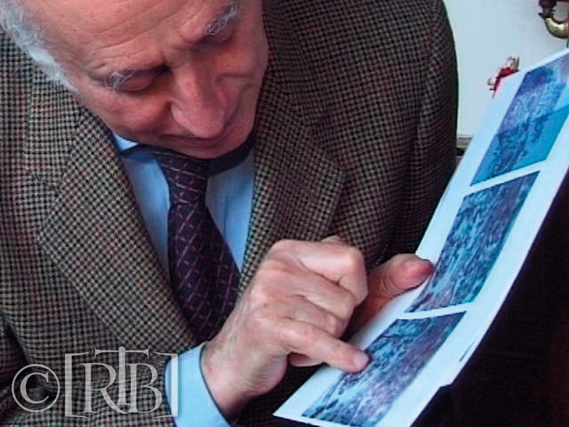 Professor Odoardo Linoli in Italy (who investigated the Lanciano miracle) examining the photographic prints of the microscopic slide